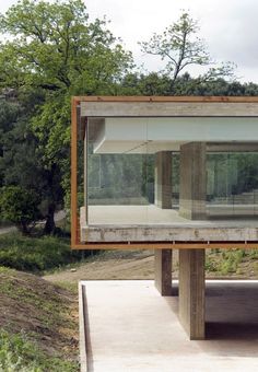 a large mirror sitting on top of a wooden platform in the middle of a forest