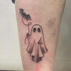 a black and white tattoo of a ghost holding a bat