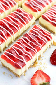 strawberry cheesecake bars with whip cream drizzled on top and strawberries in the background