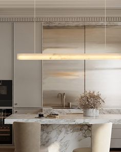 a modern kitchen with marble counter tops and stools in the center, along with an island