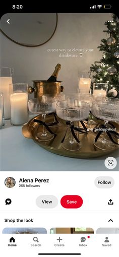 an image of a table setting with candles and wine glasses on the tray, which is being viewed on instagram