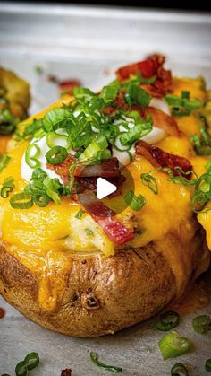 the baked potatoes are topped with bacon and green onions