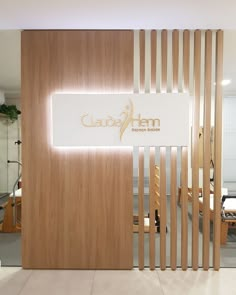 the entrance to an office with wooden slats and white signage that reads qubim