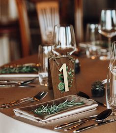 the table is set with silverware and place settings