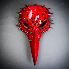 a red mask with spikes on it