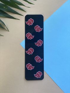 a cell phone case with red and blue elephants on it next to a green plant