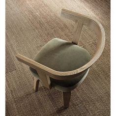 a chair with a wooden armrest and seat cushion on top of a carpeted floor