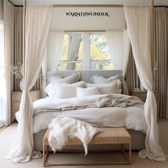 a white bed sitting under a window in a bedroom