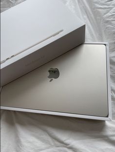 an apple box opened on top of a bed