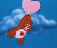 a cartoon bear flying through the air with a heart shaped balloon