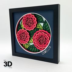 a paper art with three red roses in the center and green leaves on the bottom