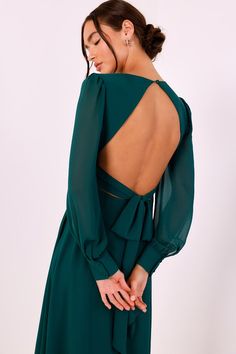 the back of a woman wearing a green dress