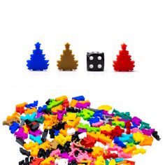 a pile of colorful plastic toys next to each other on a white surface with dices in the middle