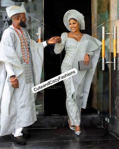 a man and woman dressed in traditional african clothing