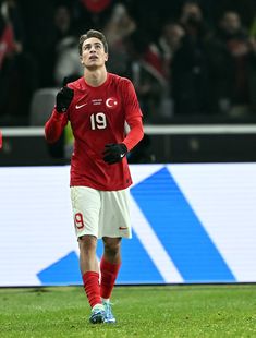 a man in red and white soccer uniform on field