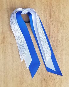 a blue and white tie on top of a wooden table