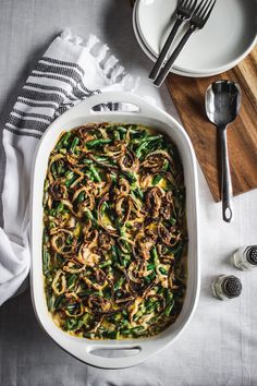 a casserole dish with green beans, onions and mushrooms in it on a table