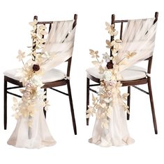 two chairs decorated with flowers and ribbons for a wedding or special event, set against a white backdrop