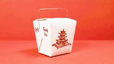 a chinese take out box on a pink background