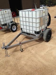 two white containers sitting on top of a trailer