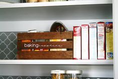 a wooden box sitting on top of a kitchen counter next to books and other items