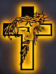 the crucifix with jesus's face is lit up in yellow light