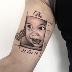 a tattoo with a child's face and name on the left side of the arm