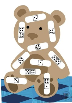 a teddy bear sitting on top of a blue and white checkered floor with dominos in it's paws