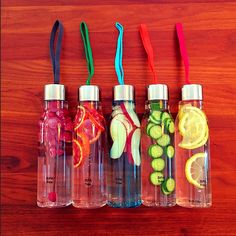 four bottles with different types of fruit in them