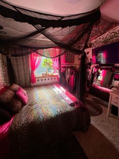 a bedroom decorated in pink and black with a leopard print bed spread on the floor