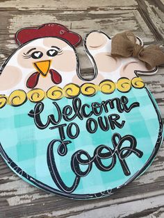 a sign that says welcome to our coop with a chicken in the center and a bow on it