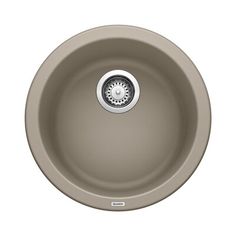 an oval sink with a drain in the middle