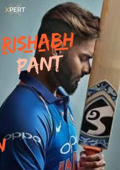 a man holding a wooden bat and wearing a blue shirt with the words rushah pant on it