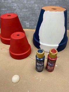 three different types of paint sitting on top of a table next to some cones and bowls