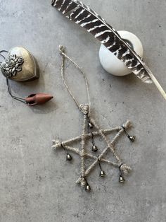 an assortment of items on a table including a feather, beads and other things to decorate