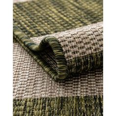 a close up view of the green and beige woven material on an area that is very soft