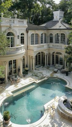 a large house with a pool in the middle and lots of windows on each side