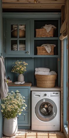 a washer and dryer in a small room with blue painted walls, open shelving