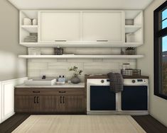 a white and brown kitchen with open shelving above the washer and dryer