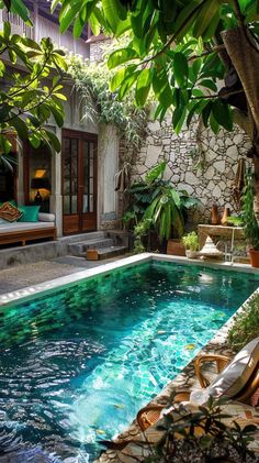 an outdoor swimming pool surrounded by greenery