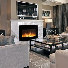 a living room filled with furniture and a fire place in the middle of the room