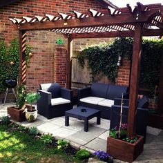 an outdoor living area with couches and tables