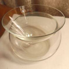 a glass bowl filled with water on top of a table