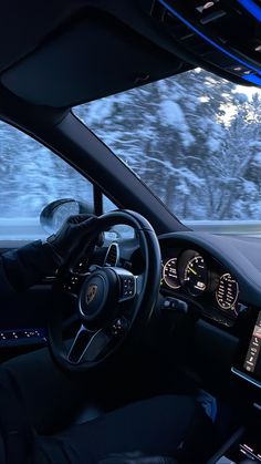 the interior of a car driving on a snowy road