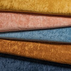 several different colored fabrics stacked on top of each other