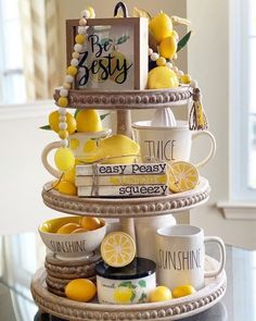 a tiered cake with lemons and coffee cups