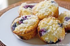 several blueberry muffins on a white plate