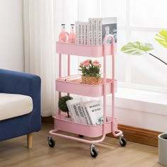 a pink cart with flowers and magazines on it