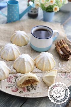 some food is sitting on a plate near a cup of coffee and cinnamon stickers