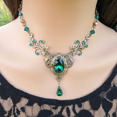 This vintage medieval styled crystal necklace features lush Emerald Swarovski crystals with nice crisp facets and brass/sterling silver embellishments. The detailed flower stampings have been in production since the 1940's and give the necklace a beautiful elven-like quality. Both elegant and stylish, this piece would be perfect for weddings, proms and other formal occasions.   Swarovski Crystals are made in Austria and are the highest quality lead free glass-cut crystals on the market, with ext Jewelry Accessories Necklace, Emerald And Gold Necklace, Fantasy Necklace Art, Fantasy Jewelry Necklace, Emerald Jewelry Necklace, Victorian Jewelry Necklace, Ornate Necklace, Medieval Necklace, Fantasy Necklace